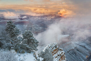 Clouds hang within the depths of the Grand Canyon as a winter storm begins to clear. For a brief moment, light fell upon Isis Temple and then faded away.