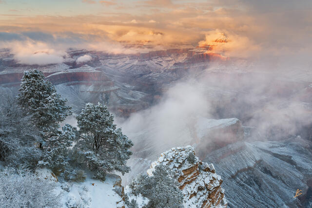 Clouds hang within the depths of the Grand Canyon as a winter storm begins to clear. For a brief moment, light fell upon Isis Temple and then faded away.