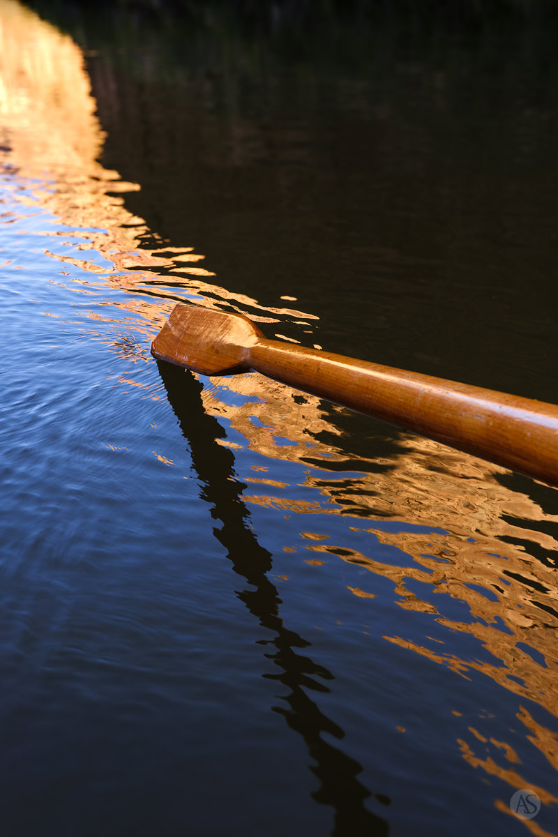 A wooden oar touches the surface of the Colorado River in the Grand Canyon.