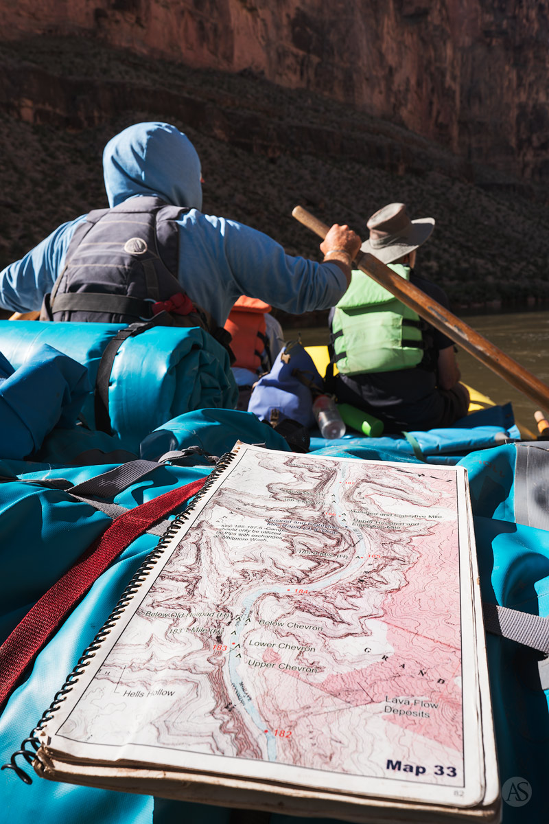 A map of the Colorado River as a boatman rows his raft downstream through the Grand Canyon.