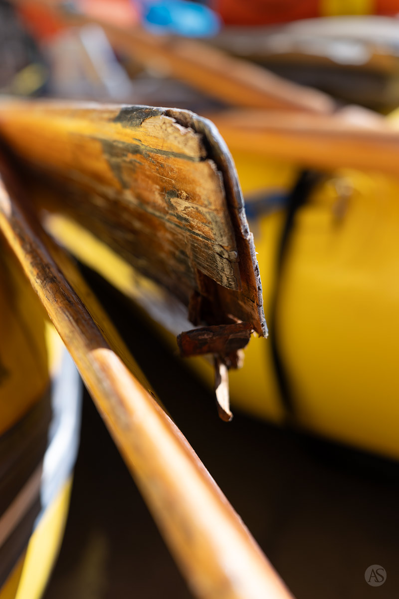 A wooden oar on a yellow raft. The oar is damaged after impacting a rock in the Colorado River.