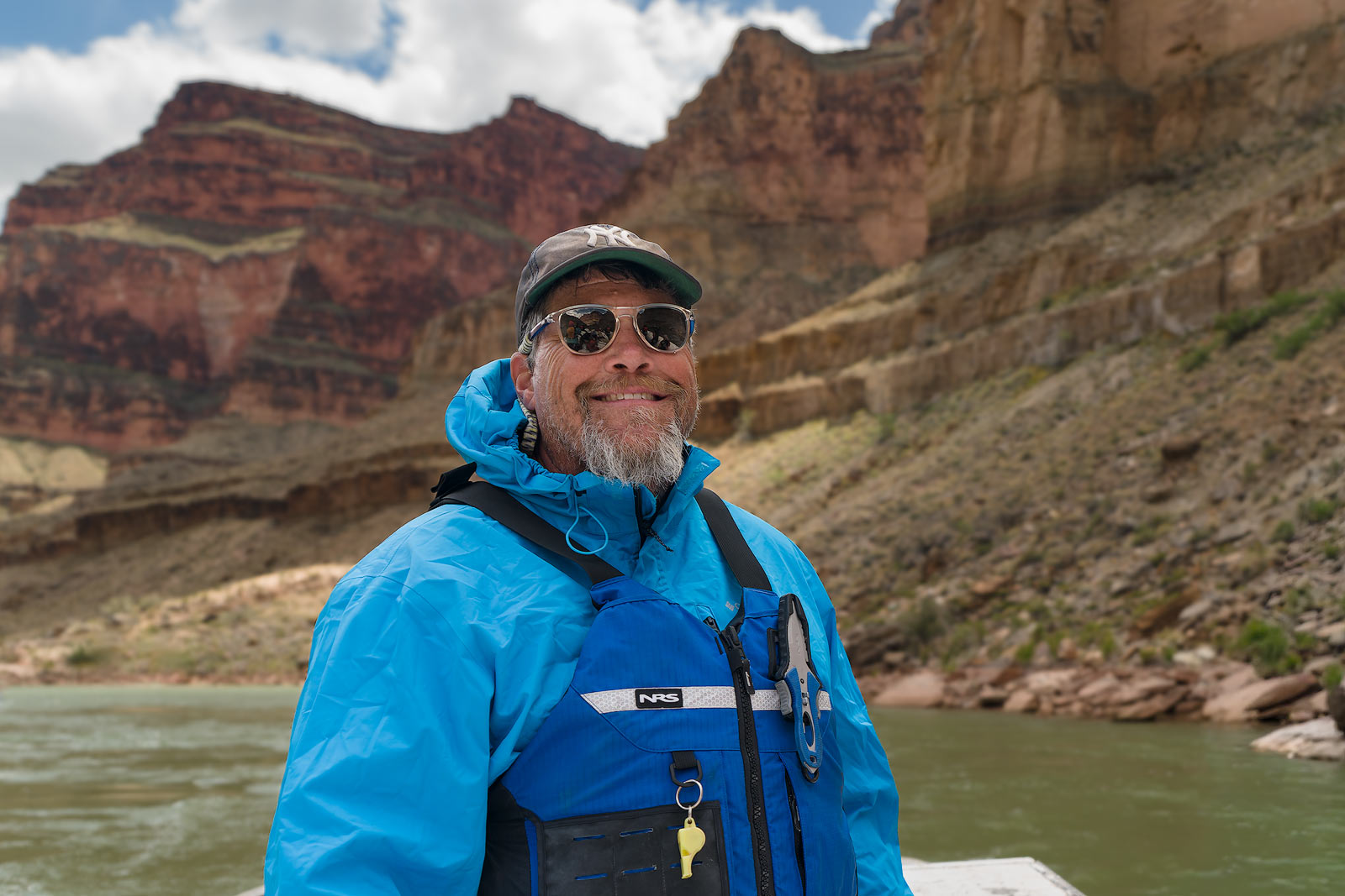 John Buggenhagen, a river guide and Trip Leader for Tour West, guides a raft on the Colorado River in the Grand Canyon.